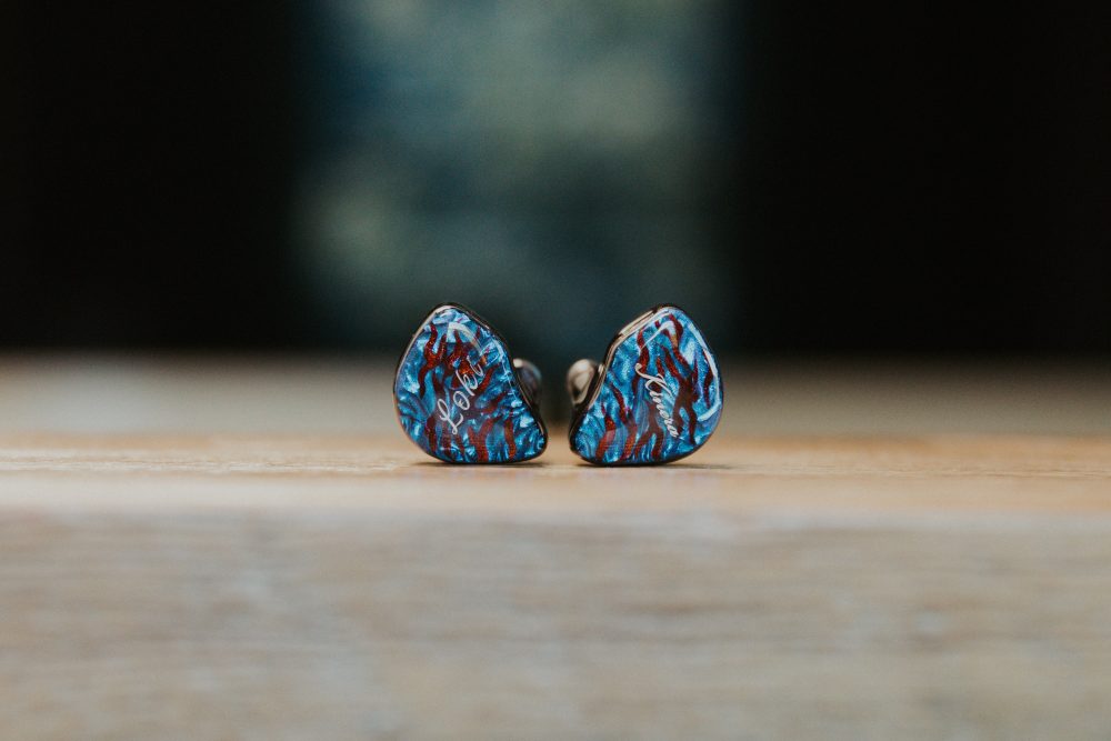 Kinera Loki iem closeup sitting on wooden table