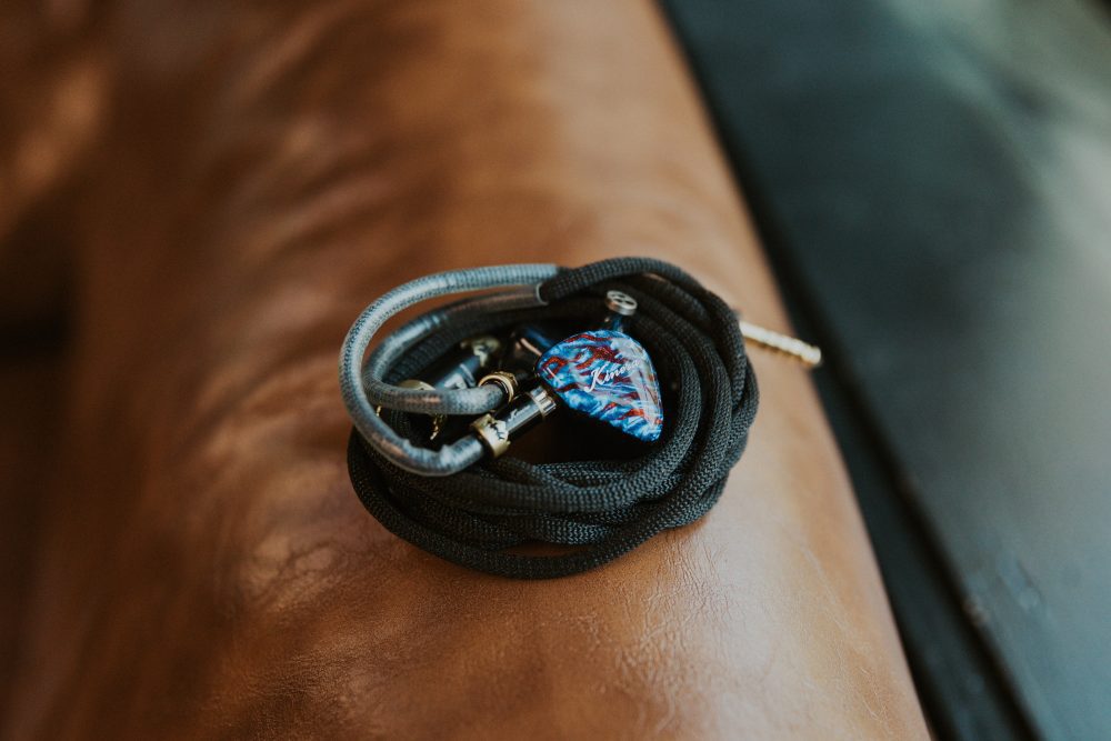 Kinera Loki iem with cable sitting on leather couch