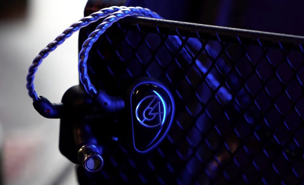 64 Audio Aspire 4 with attached stock cable hanging from black steel with blue lighting