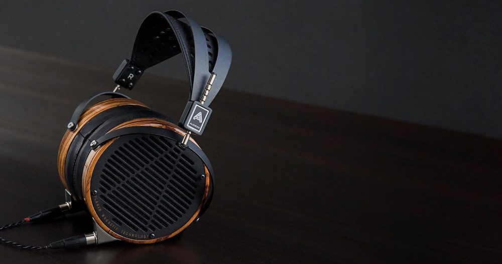 Audeze LCD3 profile with attached stock cable on left side wood table