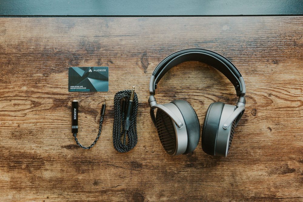 Birdseye view of Audeze MM-100 headphone and accessories included