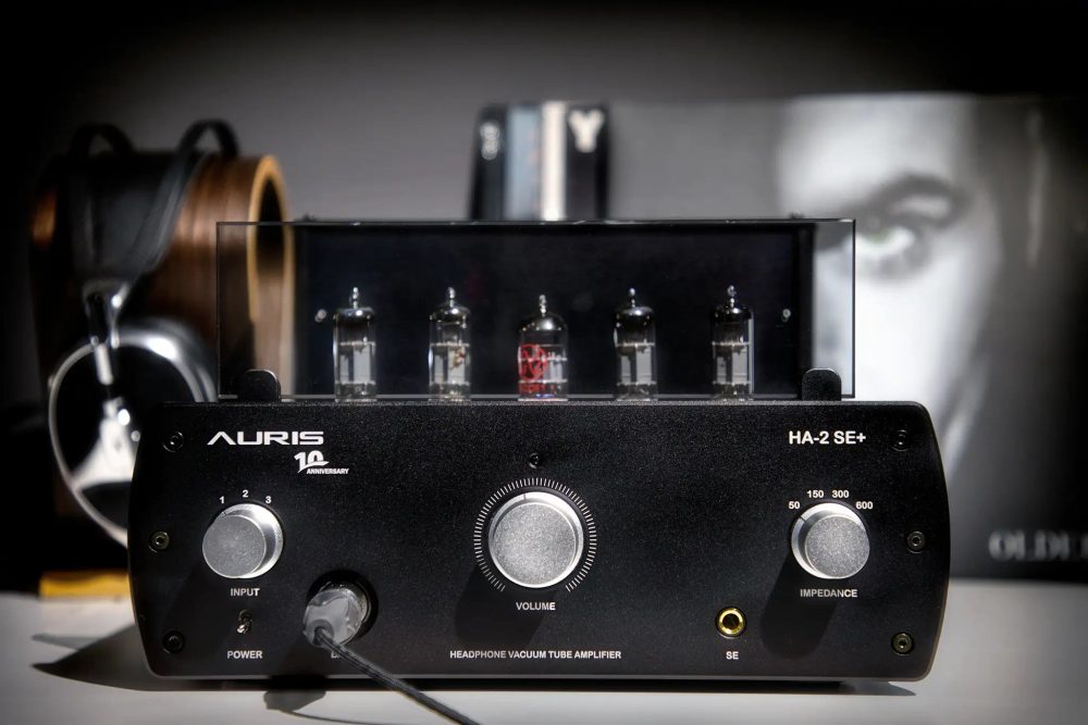 Auris Audio HA-2SE+ tube amplifier sitting on table with headphone