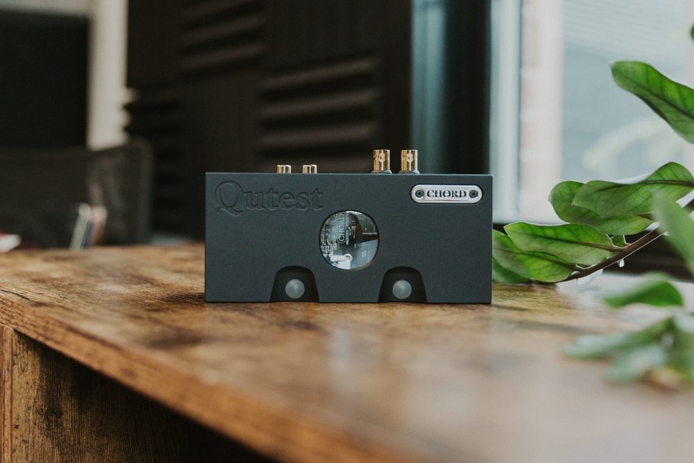 Chord electronics qutest dac standing on wooden table front view