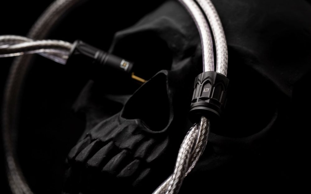 Eletech Purgatorio highlighting silver cable and bespoke Y-split over a black skull background