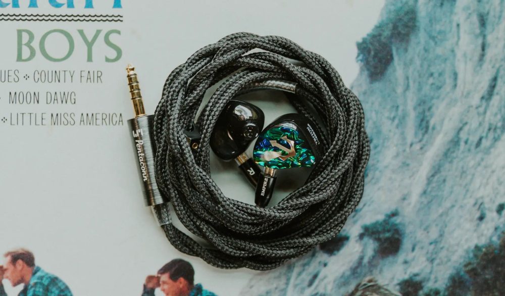 Empire Ears Triton with attached coiled limited edition Monarch cable bird's eye