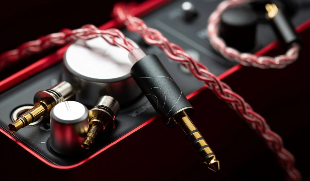 FATfreq Scarlet Mini upgraded red cable highlighting 4.4mm connector with modular tips over red amplifier