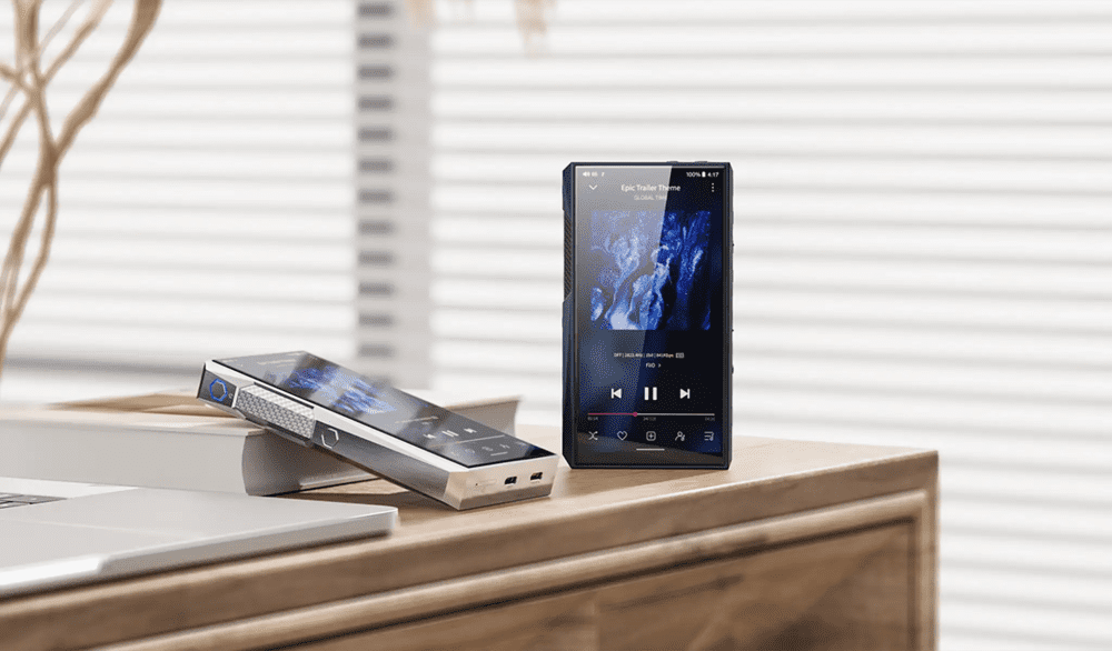 FiiO M23 DAP in stainless steel laying on book and M23 DAP in deep blue sitting on wooden table