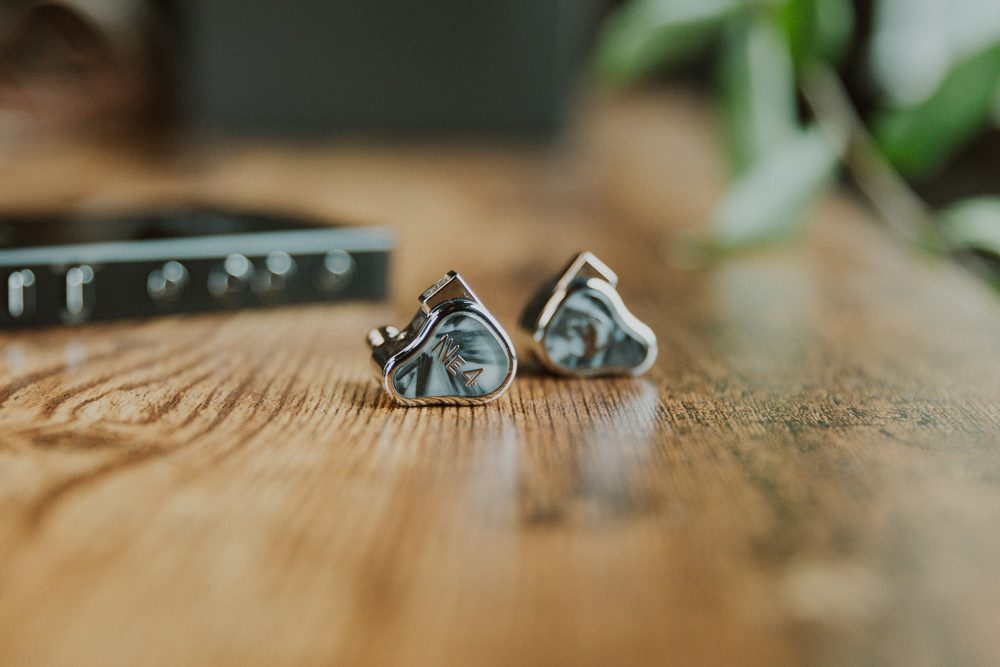 fir audio neon4 iem sitting on wooden table closeup