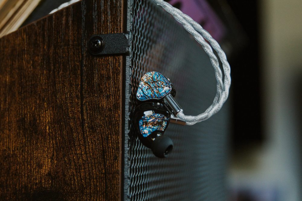 flipears aether iem closeup hanging from wooden box