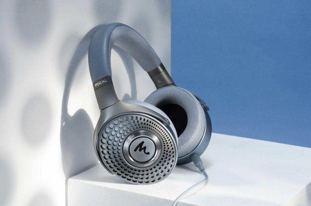 Focal Azurys headphone on white cube table leaning on white/blue wall with beehive shadow