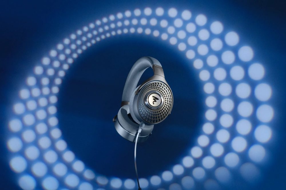 Focal Azurys front quarter with attached cable over blue background with Focal beehive pattern