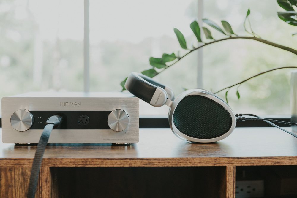 HiFiman mini shangri-la sitting on wooden table with plant on the side