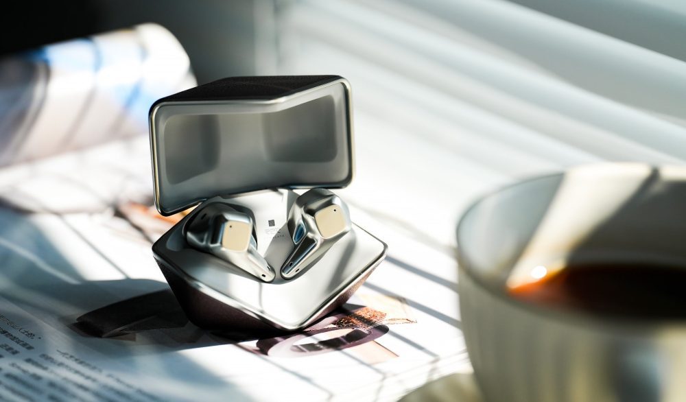 HiFiMAN Svanar LE inside open case on book with cup of coffee