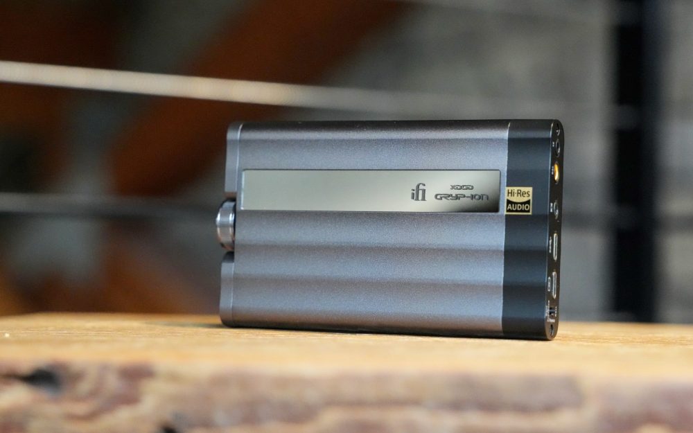 iFi xDSD Gryphon portable DAC on wood shelf highlighting logo from Bloom Audio gallery