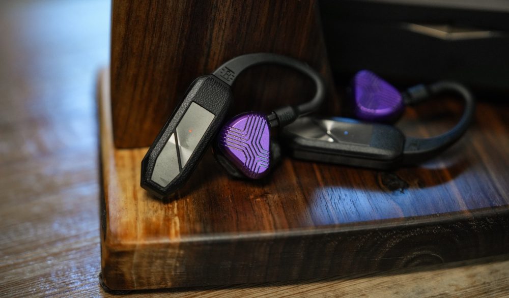 iFi GO Pods with attached Vision Ears EXT earphones on wood headphone stand from Bloom Audio gallery