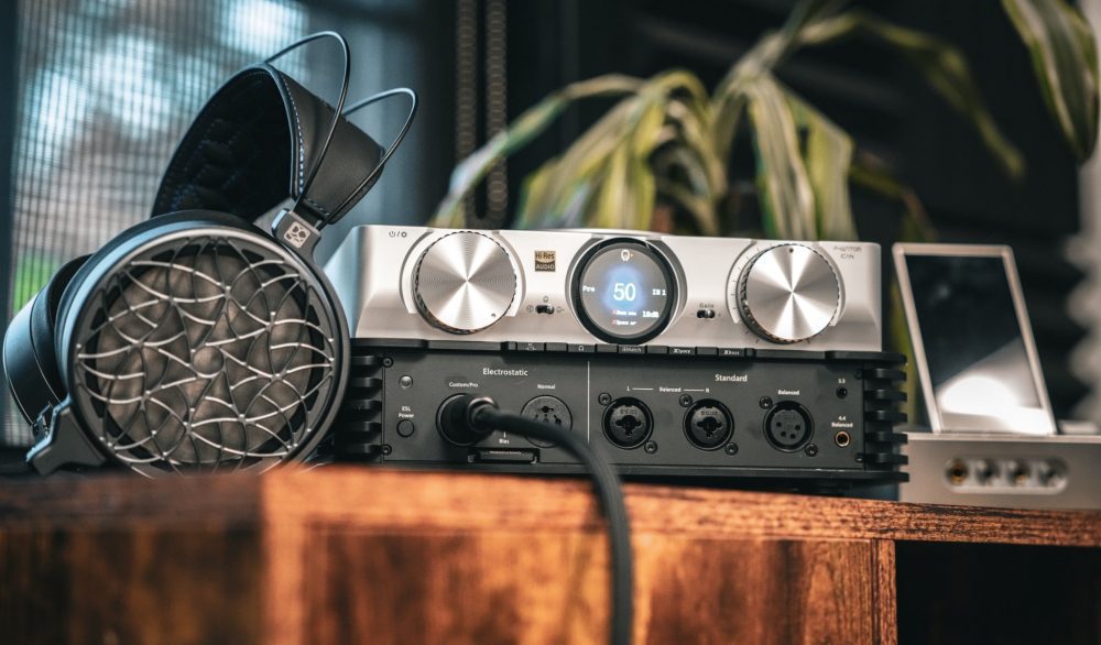 iFi iCAN Phantom front with connected Dan Clark Corina electrostatic headphones on wood table