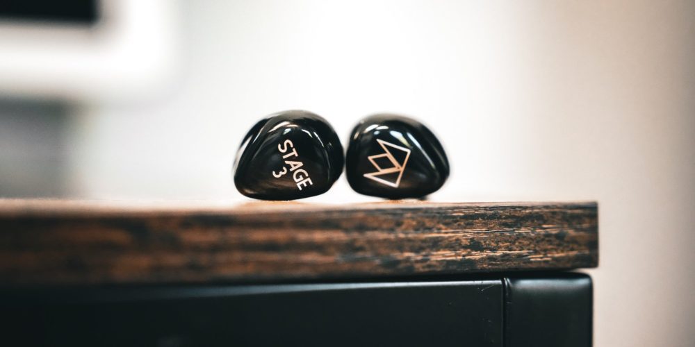 Noble Stage 3 IEMs dramatic on wood desk