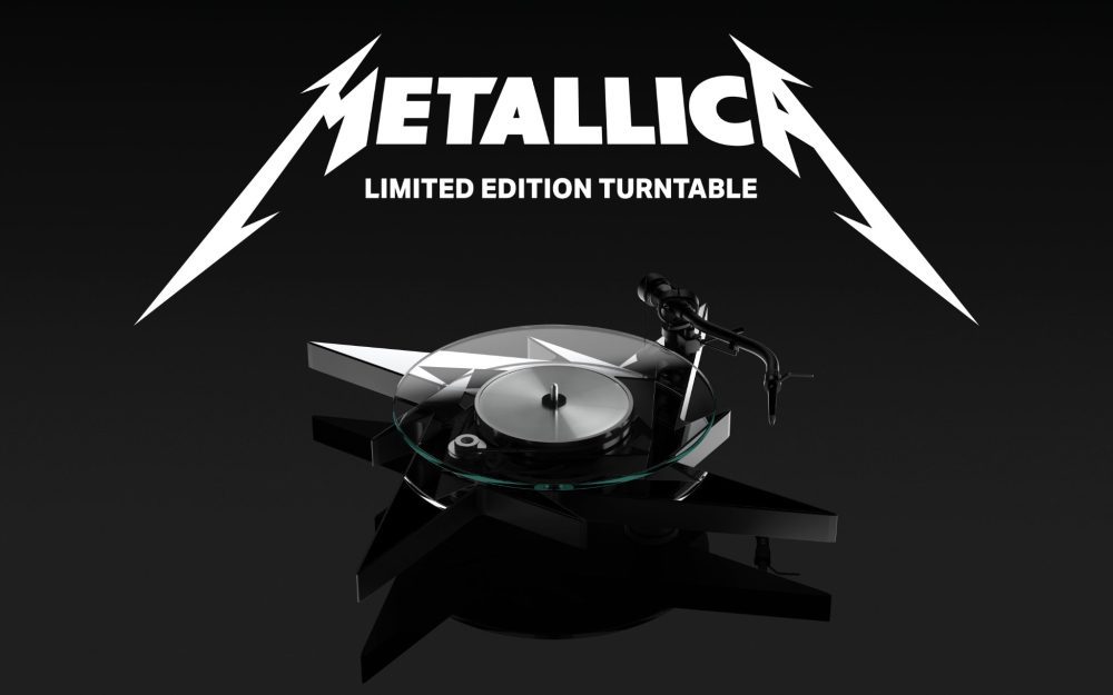 Pro-Ject Metallica turntable front quarter over black background with band logo